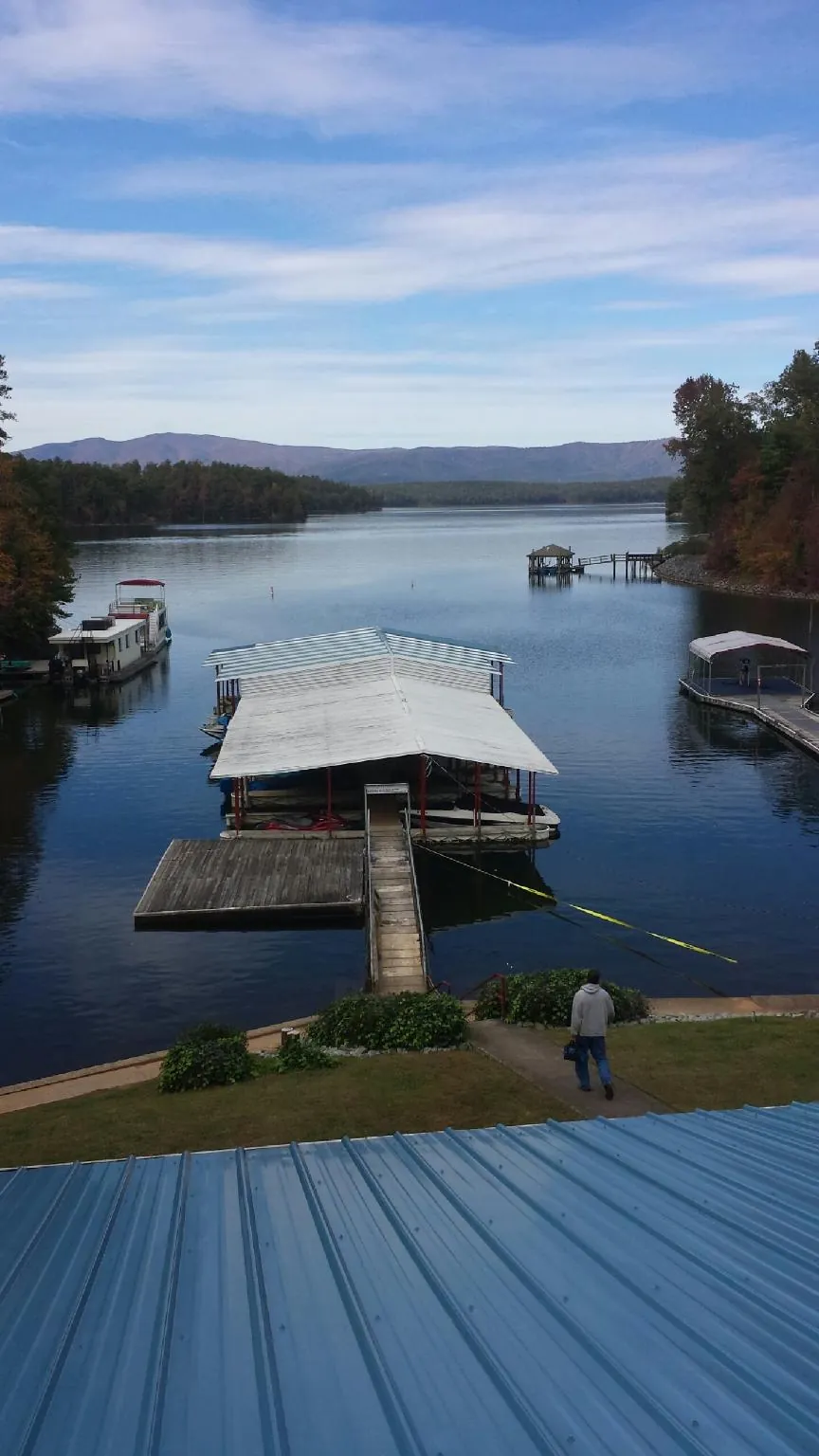 View across a lake from a newly installed blue metal roof in Oxford